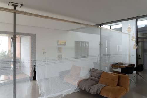 The living area in a villa was divided into two areas with a temporary curtain - during the day.