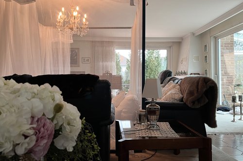 A bed in a living room.
